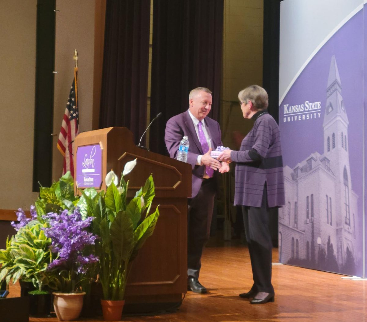 President Linton gives Gov. Laura Kelly a gift after her speech for the Landon Lecture Series.