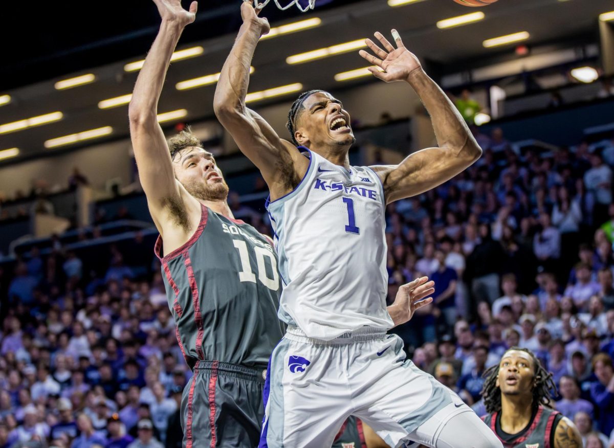 Forward David N'Guessan gets shoved by the defense as he attempts to rebound. The Wildcats fell to Oklahoma 53-73 at Bramlage Coliseum on Jan. 30, moving their record to 14-7.