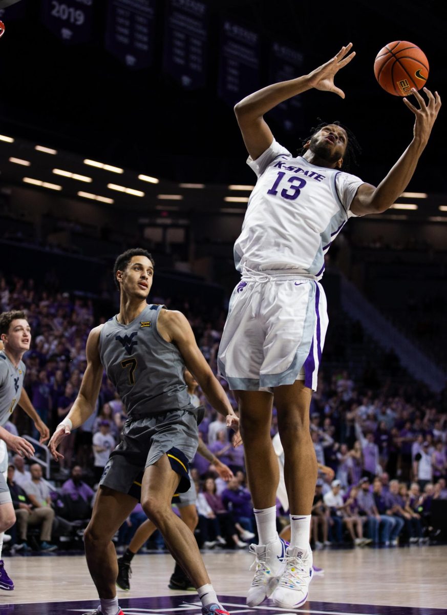 Forward Will McNair Jr. goes for a rebound against West Virginia. The Wildcats beat the Mountaineers in overtime 94-90 after blowing a 25-point lead.