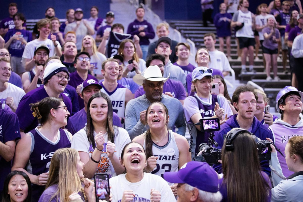 Head coach Jerome Tang celebrates in the student section after the game against West Virginia University on Feb. 26, 2024 in Bramlage Coliseum. The Wildcats beat the Mountaineers in overtime 94-90, a necessary win for K-State's March Madness hopes.