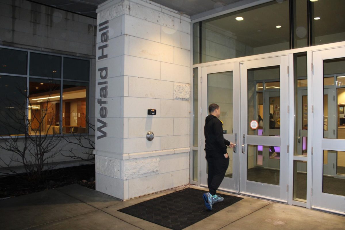 Isaiah Choma uses his student ID to get into Wefald Hall. The recent cybersecurity incident affected the times students can access Wefald without scanning their ID.