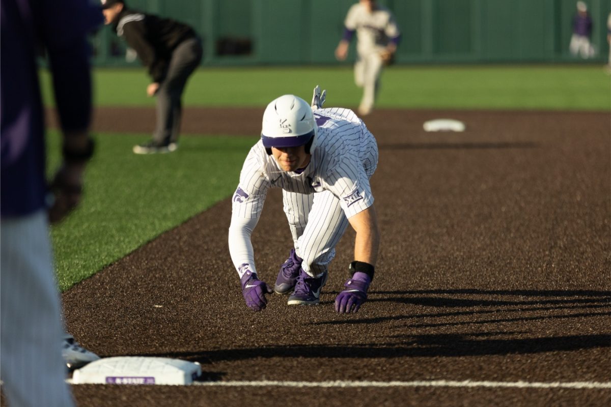 Right fielder Nick English dives back for first base against Holy Cross. The Wildcats loss to the Crusaders 13-10 in overtime on Feb. 24.