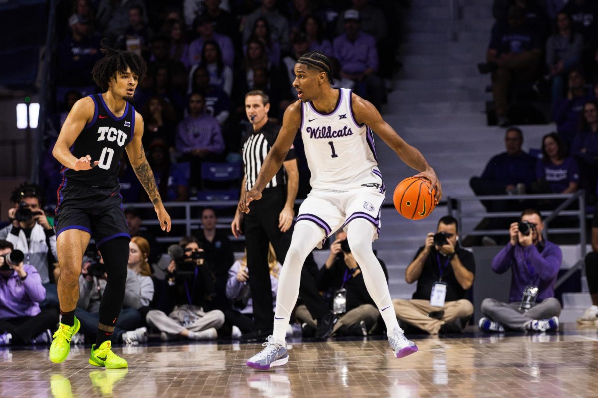 Senior David N'Guessan moves the ball away from the TCU defense. K-State lost to the TCU Horned Frogs with a final score of 75-72 following a game-winning 3-point shot on Feb. 17 at Bramlage Coliseum.