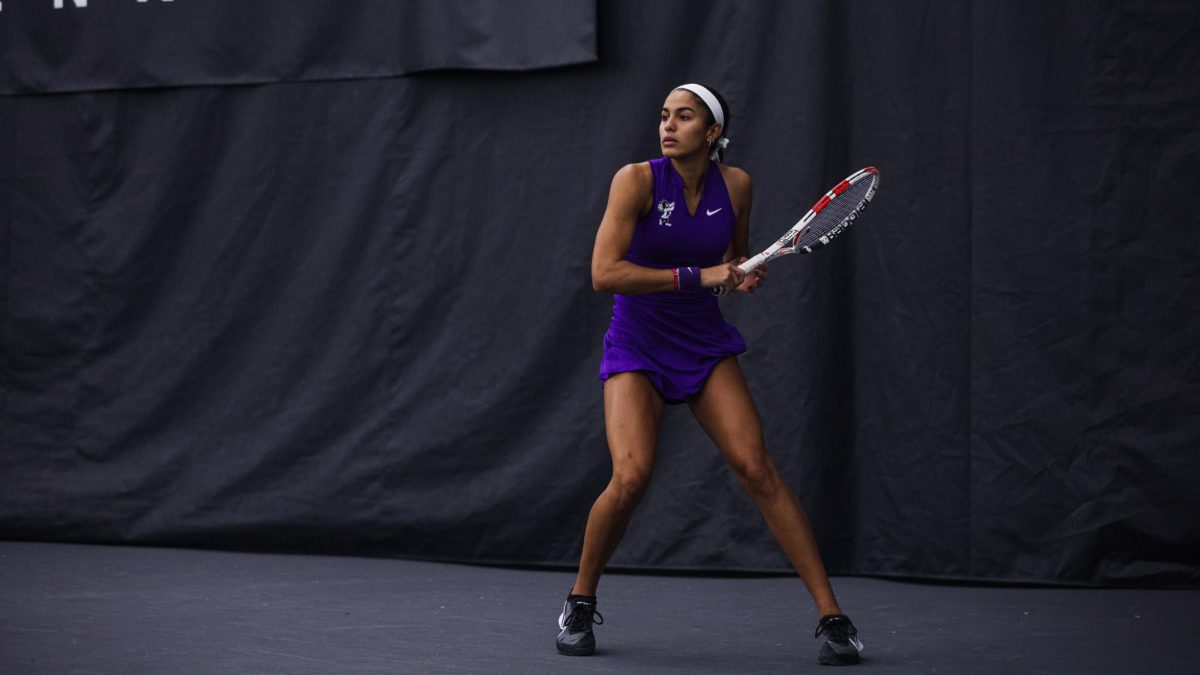 Sophomore Vanesa Suarez prepares to return a backhand shot against South Dakota on Jan. 28 at Body First Tennis Center in Manhattan. The Wildcats swept South Dakota 7-0 as Suarez won as the No. 1 seed 6-3 6-2. (Photo Courtesy of Reece Bachta | K-State Athletics)