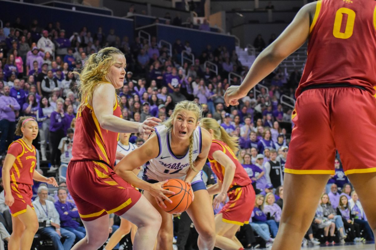 Guard Gabby Gregory fights through an Iowa State defender in the 82-76 Wildcat loss. Gregory was honored on senior night along with center Ayoka Lee and guard Rebekah Dallinger.