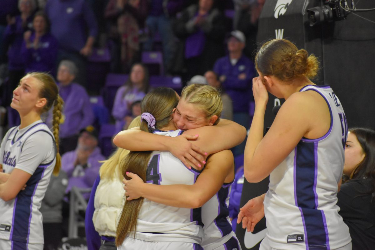 Guard Gabby Gregory and guard Rebekah Dallinger embrace one another on senior night.