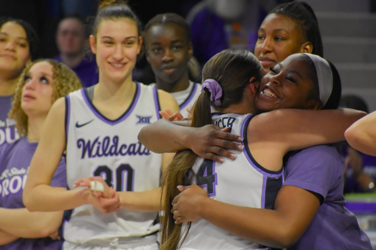 Guard Rebekah Dallinger embraces her guard Ja'Mia Harris during senior night.