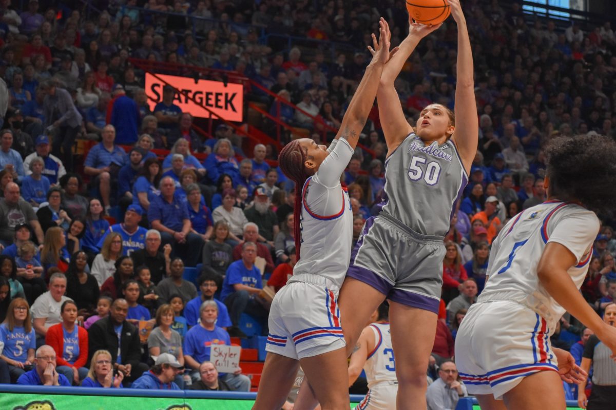 Center Ayoka Lee goes for a jumper against Kansas center Taiyanna Jackson. Because of Jackson's defense, Lee shot 7-21 against the Jayhawks in K-State's 55-58 loss.