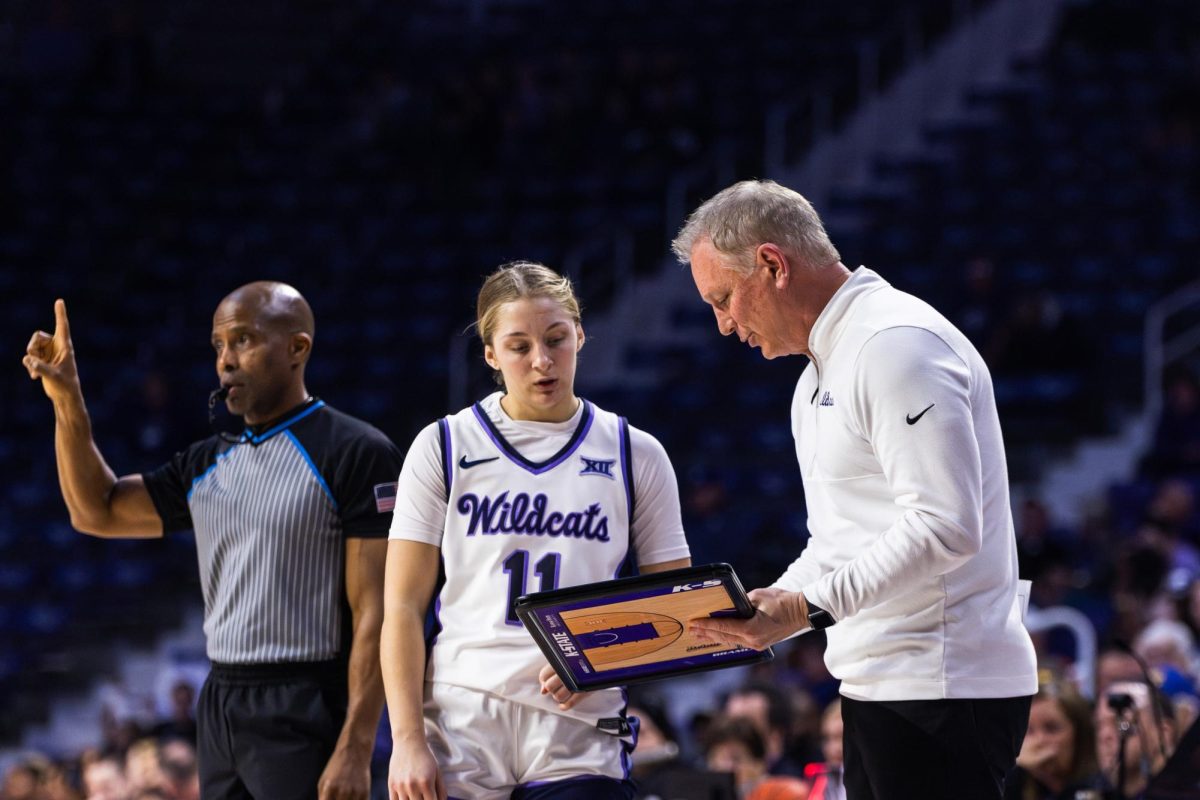 Head coach Jeff Mittie shows guard Taryn Sides a play during the West Virginia game on Feb. 21. Sides will be a key player in K-State's Iowa State matchup on Feb. 28.