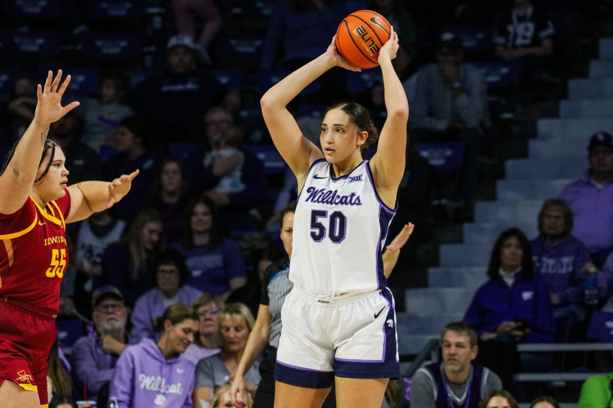 Center Ayoka Lee looks in the paint for the open player. K-State fell to Iowa State on senior night 82-76 Feb. 28.