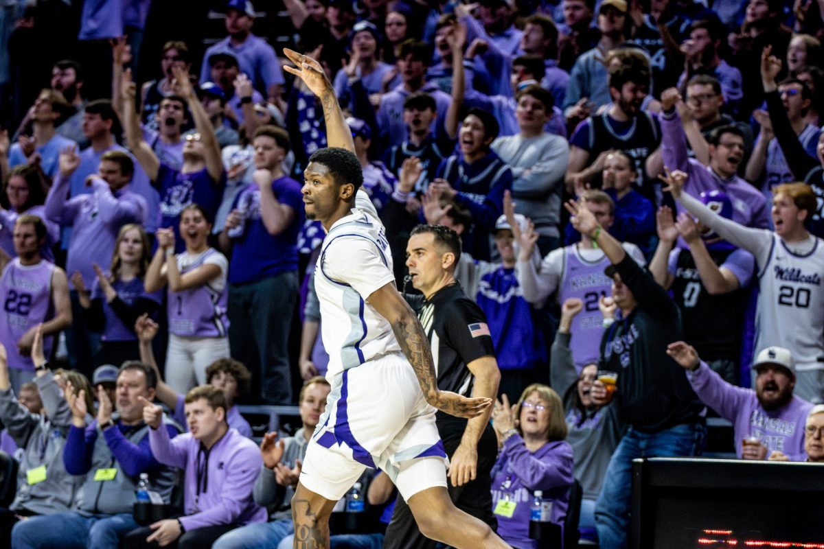 Guard Cam Carter puts his hand up in the "3" sign after hitting a 3-pointer against Iowa State. Carter went 3-8 on 3s in the 65-58 upset, finishing the game with 21 points.