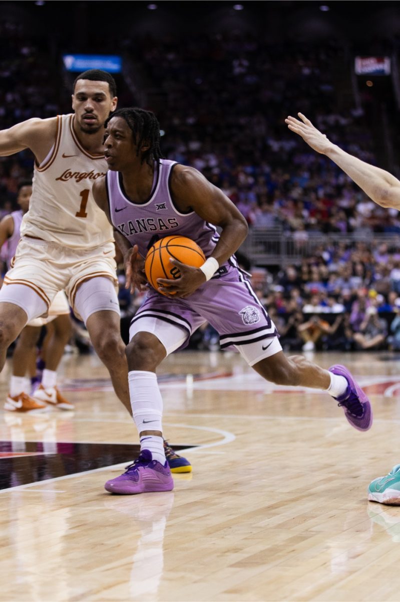 Guard Dai Dai Ames drives to the basket against Texas in the second round game of the Big 12 tournament. Ames ended the night with double-digit points: 10 in the second half.