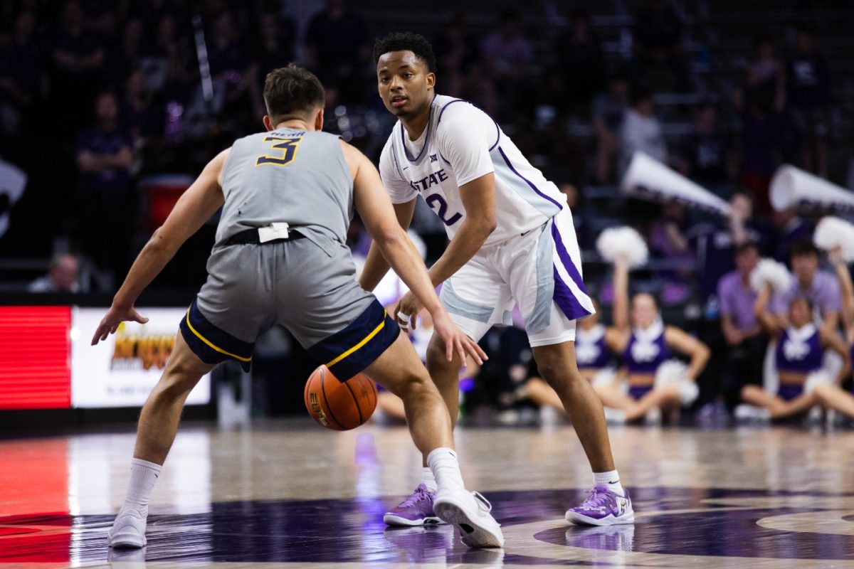 Tylor Perry dribbles the ball against West Virginia Feb. 26 in the Wildcats' 94-90 overtime victory. Against Cincinnati on Saturday, Perry topped the scoring chart with 26 points in the Wildcats' 74-72 loss.