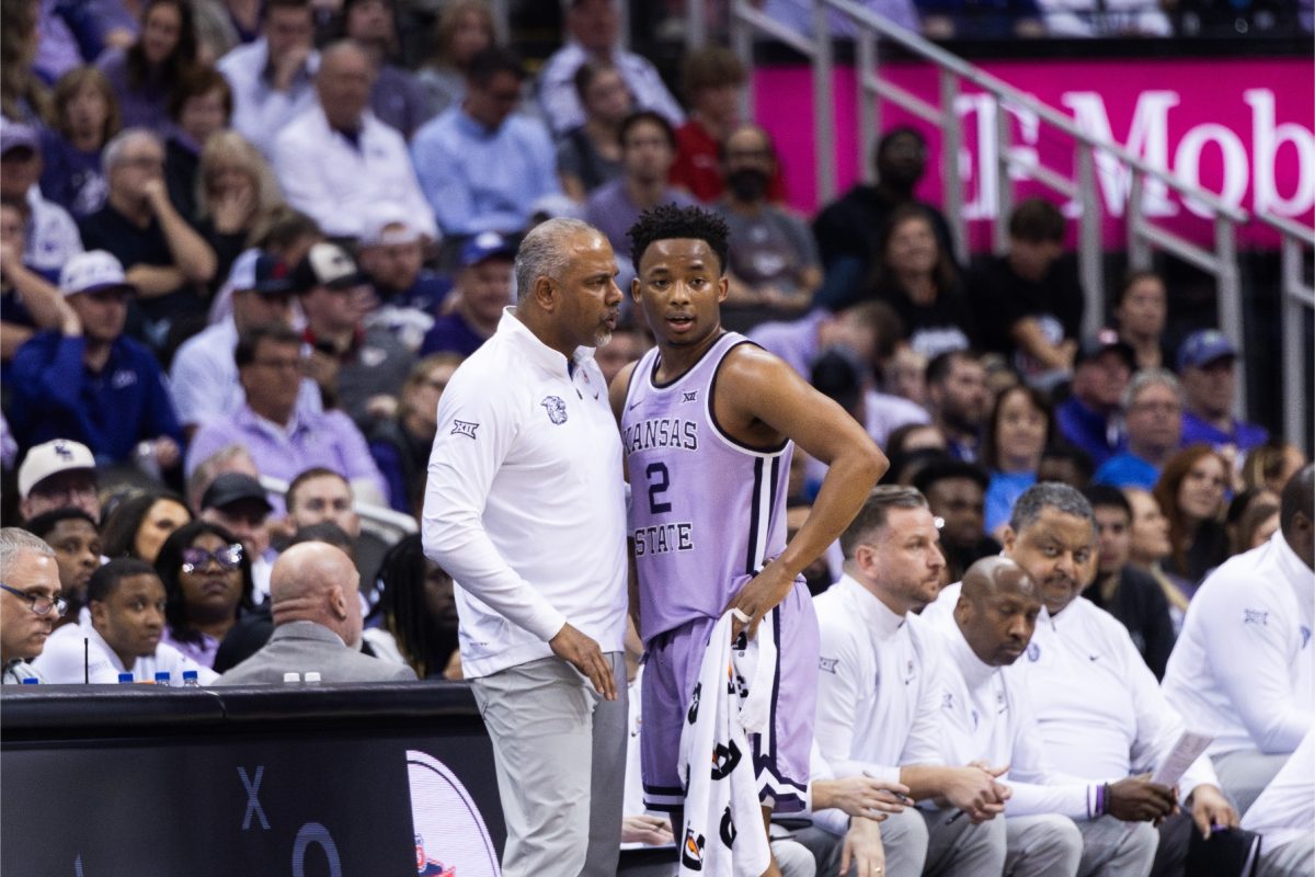 Head coach Jerome Tang speaks with guard Tylor Perry before returning to the court in the Big 12 tournament game against Texas. The Wildcats did not make the NCAA tournament, holding a 19-14 record after the conference tournament.