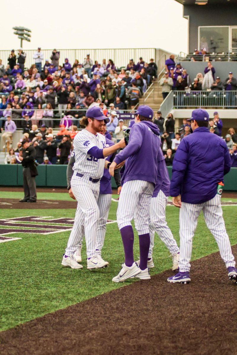 Pitcher Jackson Wentworth is celebrated my his team and the crowd coming back to the dugout. He threw six innings, allowing one run and pitching the first four hitless.