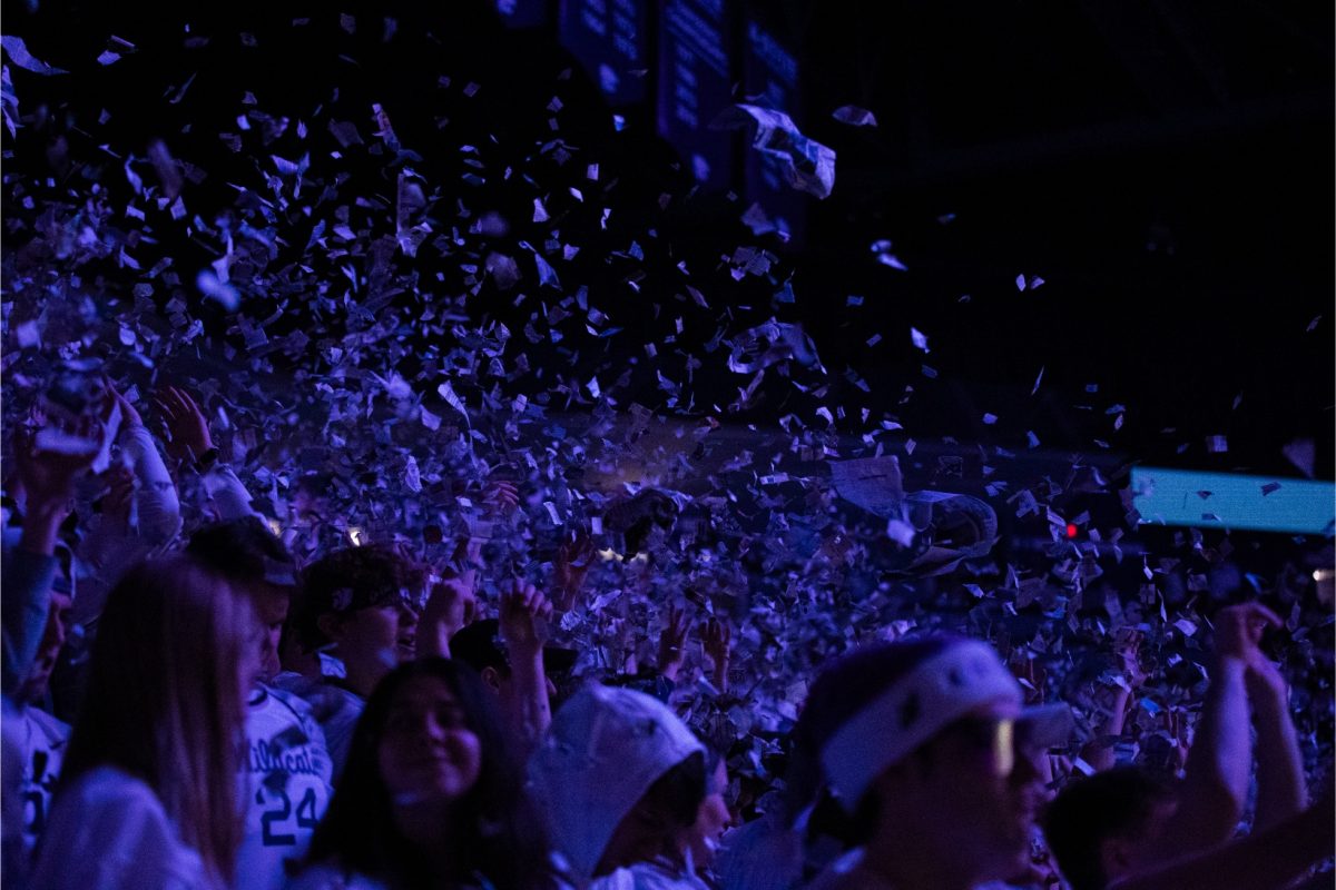 The student section throws newspaper as the starting lineup is announced before K-State's game against Villanova on Dec. 5, 2023. K-State won 72-71 in overtime in Bramlage Coliseum.