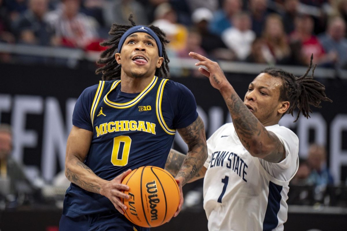 K-State transfer guard Dug McDaniel drives past a Penn State guard Ace Baldwin Jr. in the 66-57 loss in the Big 10 tournament. McDaniel, who scored seven points and collected six assists in the loss, committed to Kansas State on Wednesday. (Photo courtesy of Grace Lahti and The Michigan Daily)