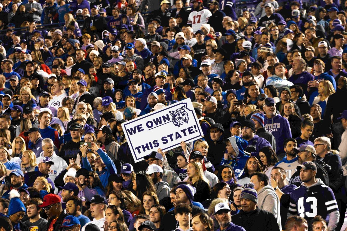 Kansas State fans hold up a "We Own This State" sign at the K-State vs. Kansas football game. The Wildcats beat the Jayhawks 31-27 on Nov 18. at David Booth Kansas Memorial Stadium.