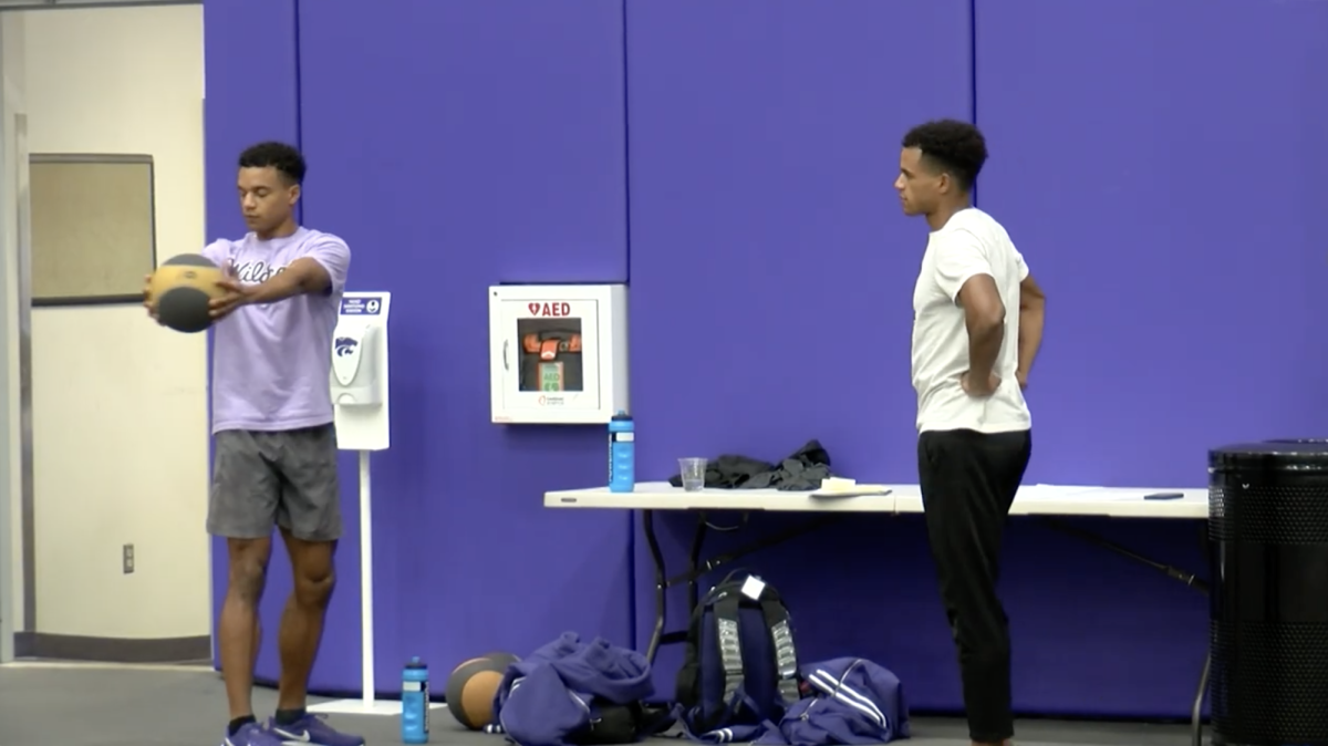 Twins Eugene and Jaimie Omalla warm up prior to practice. The brothers, who hail from Uganda, make up part of K-State's record breaking 4x400 relay team.