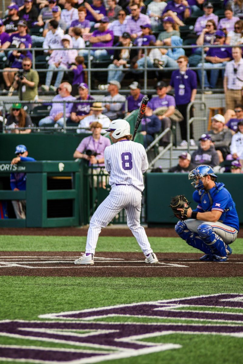 Freshman Nick English steps up to bat with his brother, Jake English, behind the plate for Kansas. The Jayhawks won 4-0 in the second game of the Sunflower Showdown.