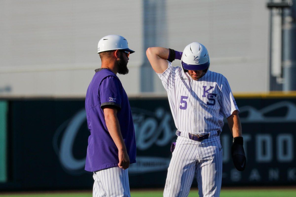 Junior Brendan Jones talks with his third base coach after stealing third against Omaha on April 23. Kansas State baseball won 6-4 at Tointon Family Stadium.