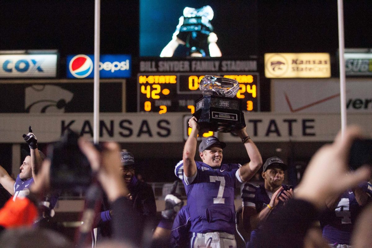 Senior quarterback Collin Klein holds up the 2012 Big 12 championship trophy after defeating Texas at Bill Snyder Family Stadium. Klein became the Wildcats' second Heisman finalist.