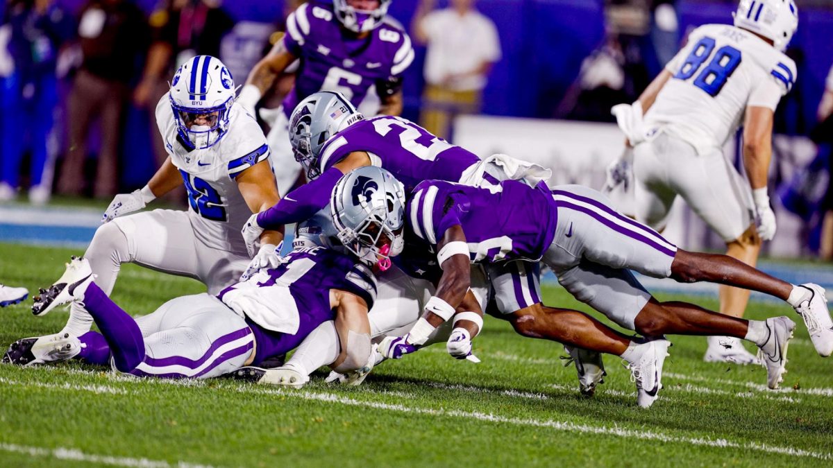 K-State tacklers flock to a BYU ball-carrier in the two teams' first matchup as conference foes. BYU defeated K-State 38-9 in Provo. (Photo courtesy of K-State Athletics)