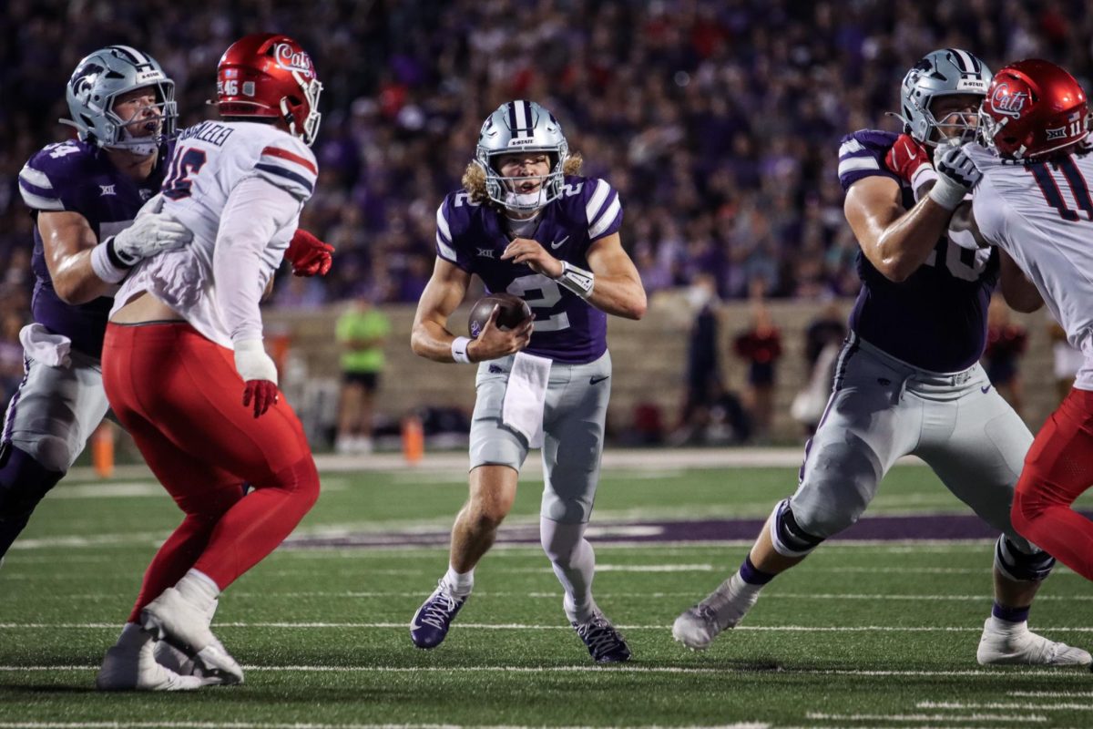 Quarterback Avery Johnson rushes between defenders in a 31-7 win against then-No. 20 Arizona on Friday, Sept. 13. Johnson rushed for a career-high 110 yards. 