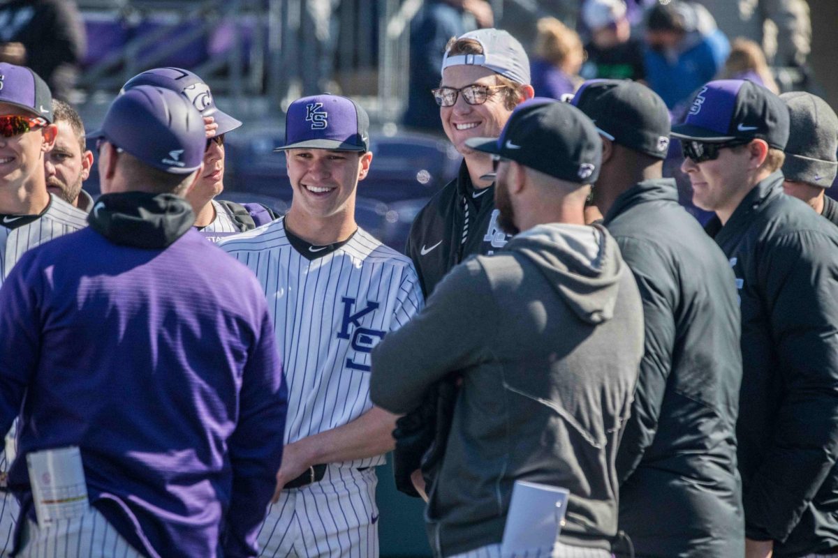 Junior Will Brennan laughs with coaches after a 5-4 win against Texas Tech in 2019. He was selected in the 8th round of the 2019 MLB draft. 