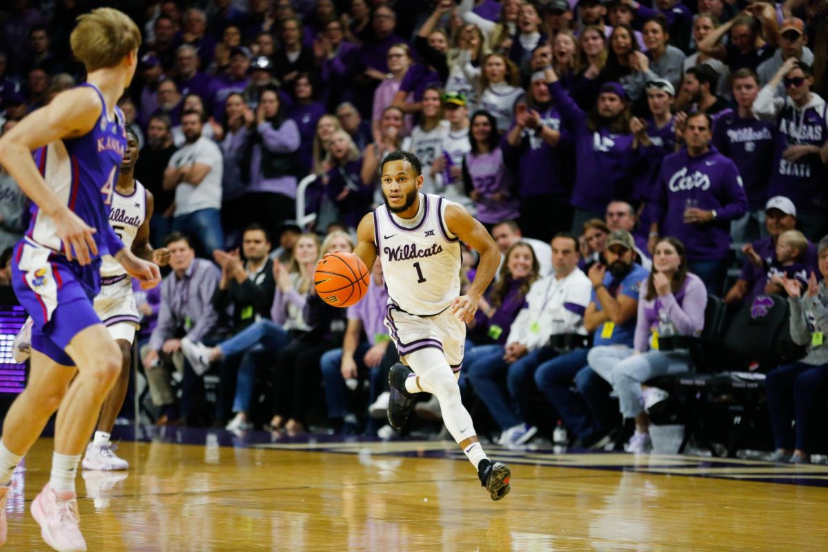 Dribbling the ball, senior guard Markquis Nowell anticipates the next play. K-State mens basketball played the University of Kansas Jayhawks on January 17, 2023. K-State beat KU 83-82 in overtime in a sold out Bramlage Coliseum.