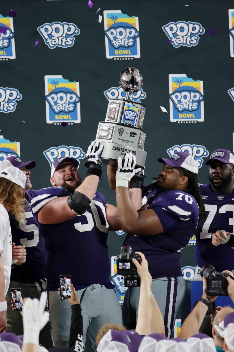 Cooper Beebe celebrates with KT Leveston after receiving the Pop-Tarts Bowl Trophy. The Wildcats won the bowl game on Dec 28, 2023 with a final score of 28-19 against North Carolina State. 