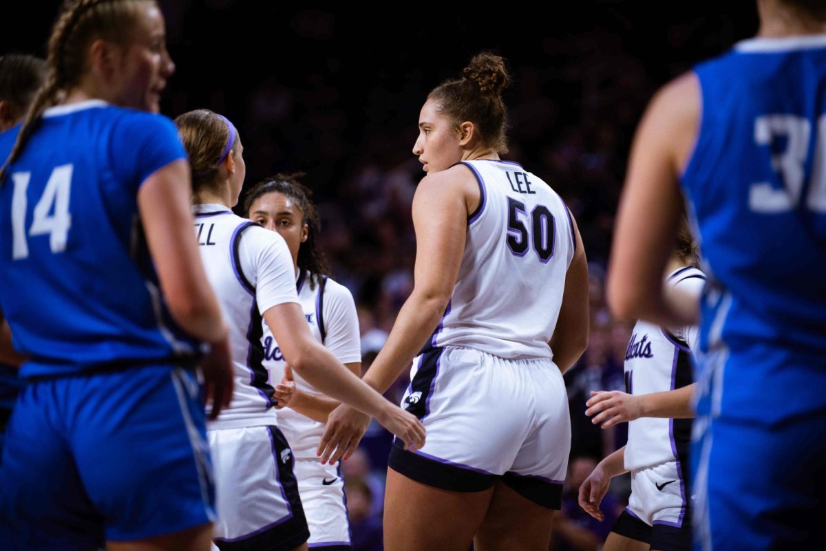 Center Ayoka Lee gathers with teammates during K-State's 86-68 win over Creighton on Nov. 14. Lee led scorers with 28 points in just 16 minutes.