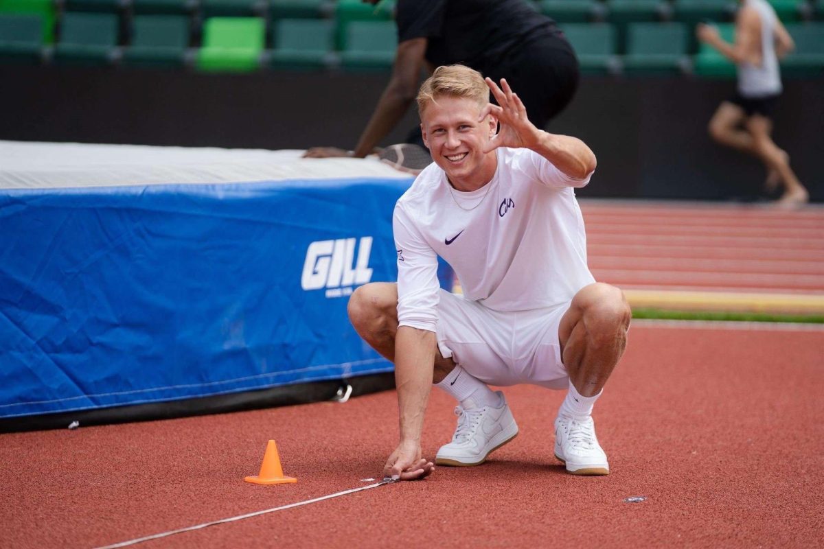 K-State decathlete Emil Uhlin flashes the signature Wildcats hand sign at a track and field event. Uhlin, a native of Sweden has adjusted to life in Manhattan with help from teammates and coaches. (Photo courtesy of K-State Athletics)