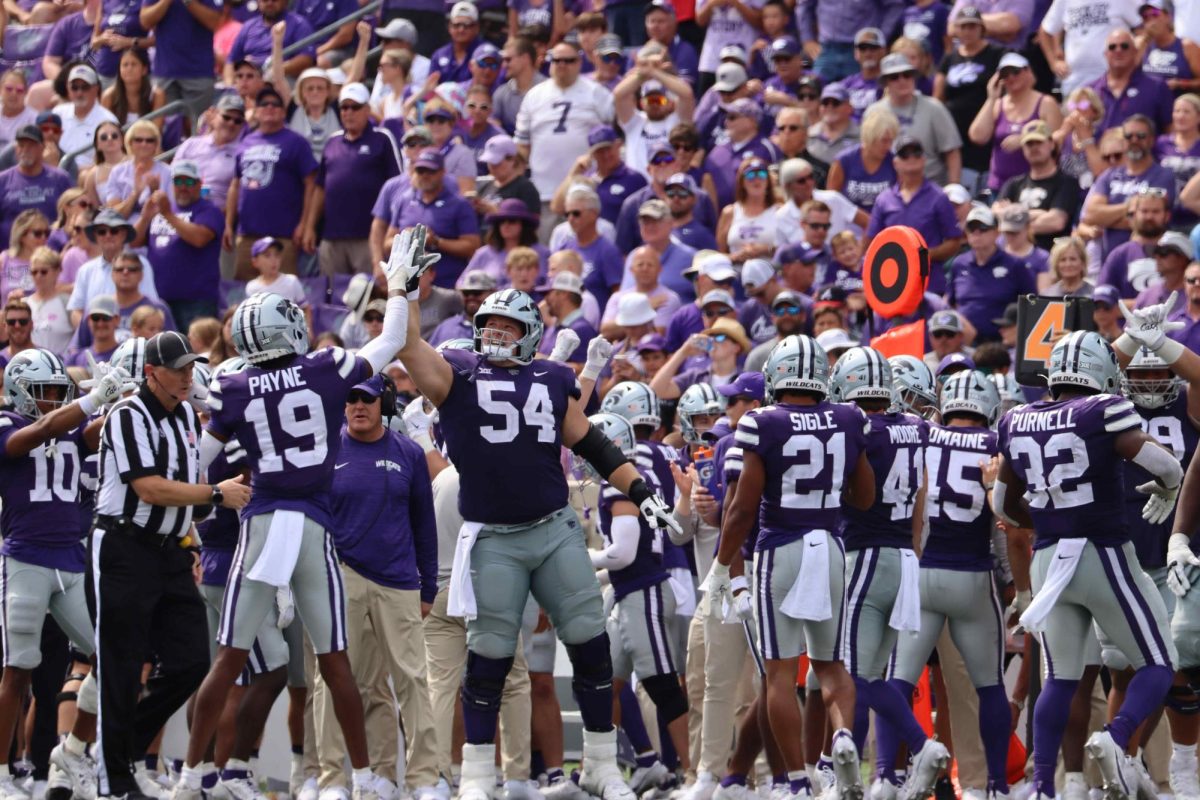 Junior offensive lineman Hadley Panzer and sophomore safety VJ Payne high five in the second half of the game against Troy. The Wildcats beat Troy University 42-13 at Bill Snyder Family Stadium on September 9th. 