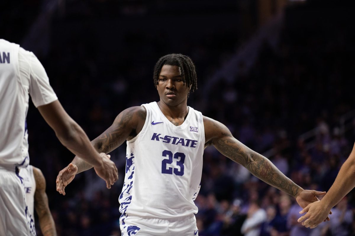 Players congratulate wing Macaleab Rich after a successful free throw. Kansas State defeated Arkansas-Pine Bluff, 120-73 on Dec. 1. 