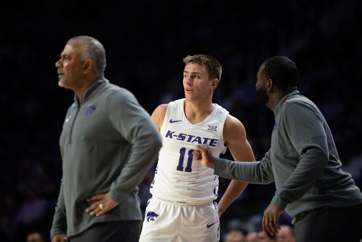 Associate Head Coach Ulrich Maligi talks to guard Brendan Hausen as Head Coach Jerome Tang calls out to the Wildcats during free throws. The Wildcats tacked on 19-points through free throws during their 120-73 win over Arkansas-Pine Bluff.