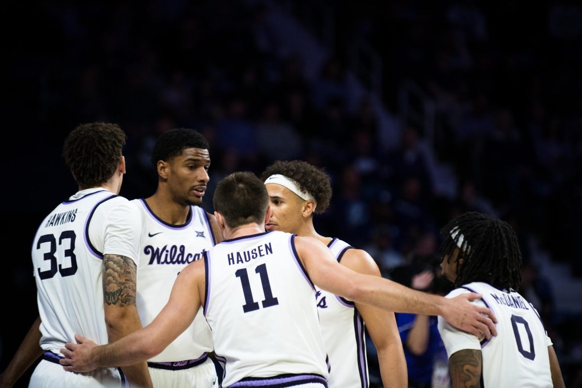 Left to right, Coleman Hawkins (33), David N'Guessan (1), Brendan Hausen (11), Max Jones (2) and Dug McDaniel (0) huddle during a break in play during the opening minutes against Cincinnati. The starting lineup would combine for 61 points as the Wildcats opened up Big 12 play with a 70-67 win over Cincinnati on Dec. 30.